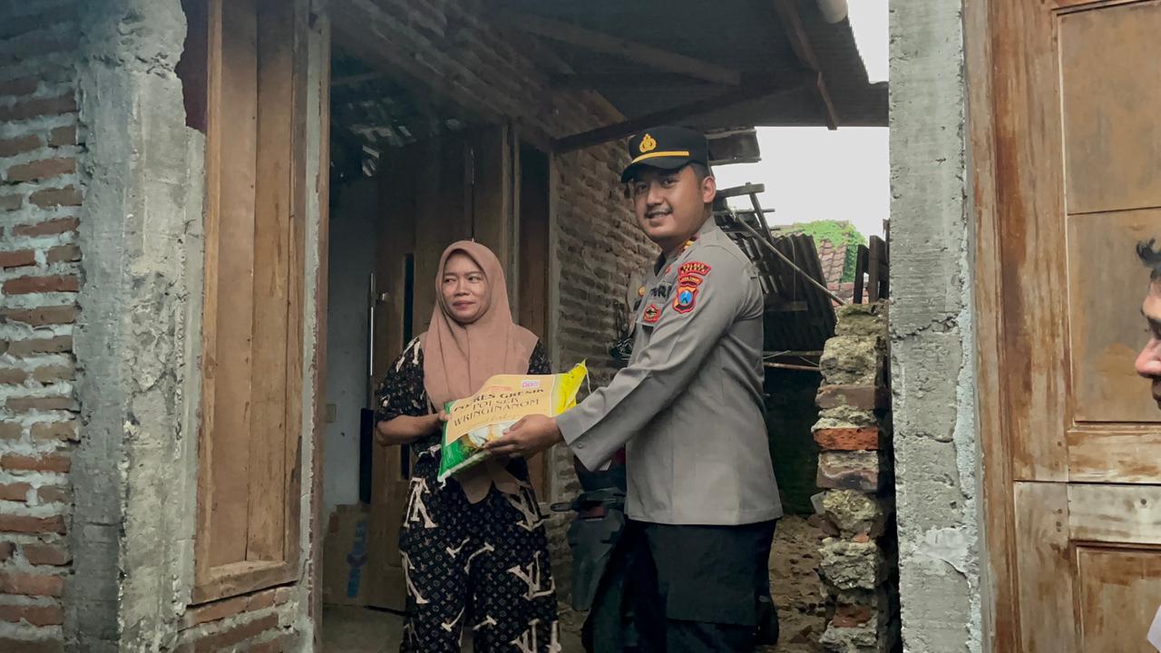 Kapolsek Wringinanom Iptu Ahmad Fahri bagi beras SPHP ke warga kurang mampu